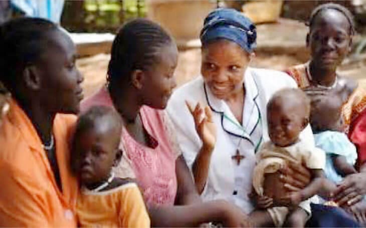 African nurse helping mom and kids