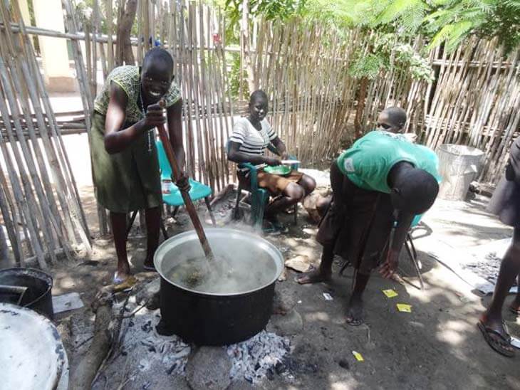 South Sudan woman stirring pot