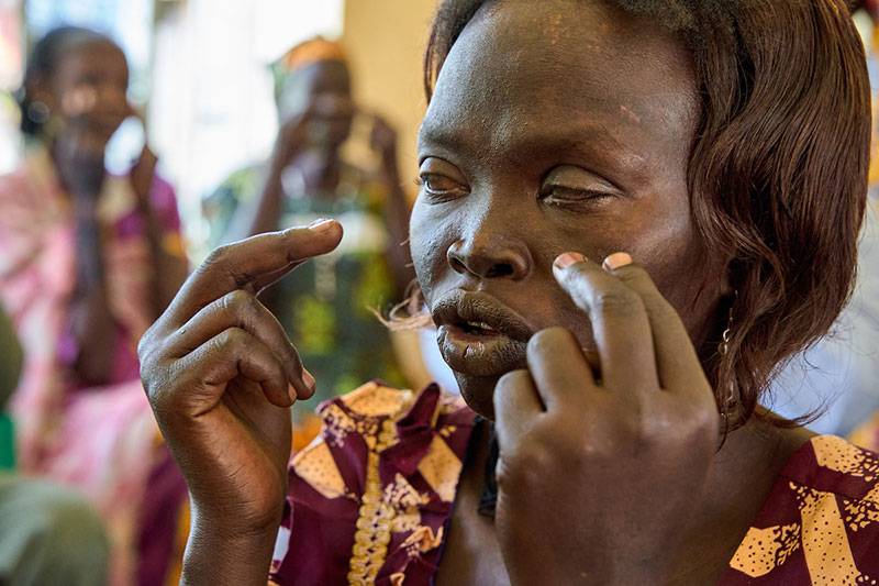 Joyce Charles taps her face during a trauma healing workshop at the Rejaf School for the Blind in Juba, South Sudan.